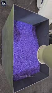Purple plastic granules in a machine hopper